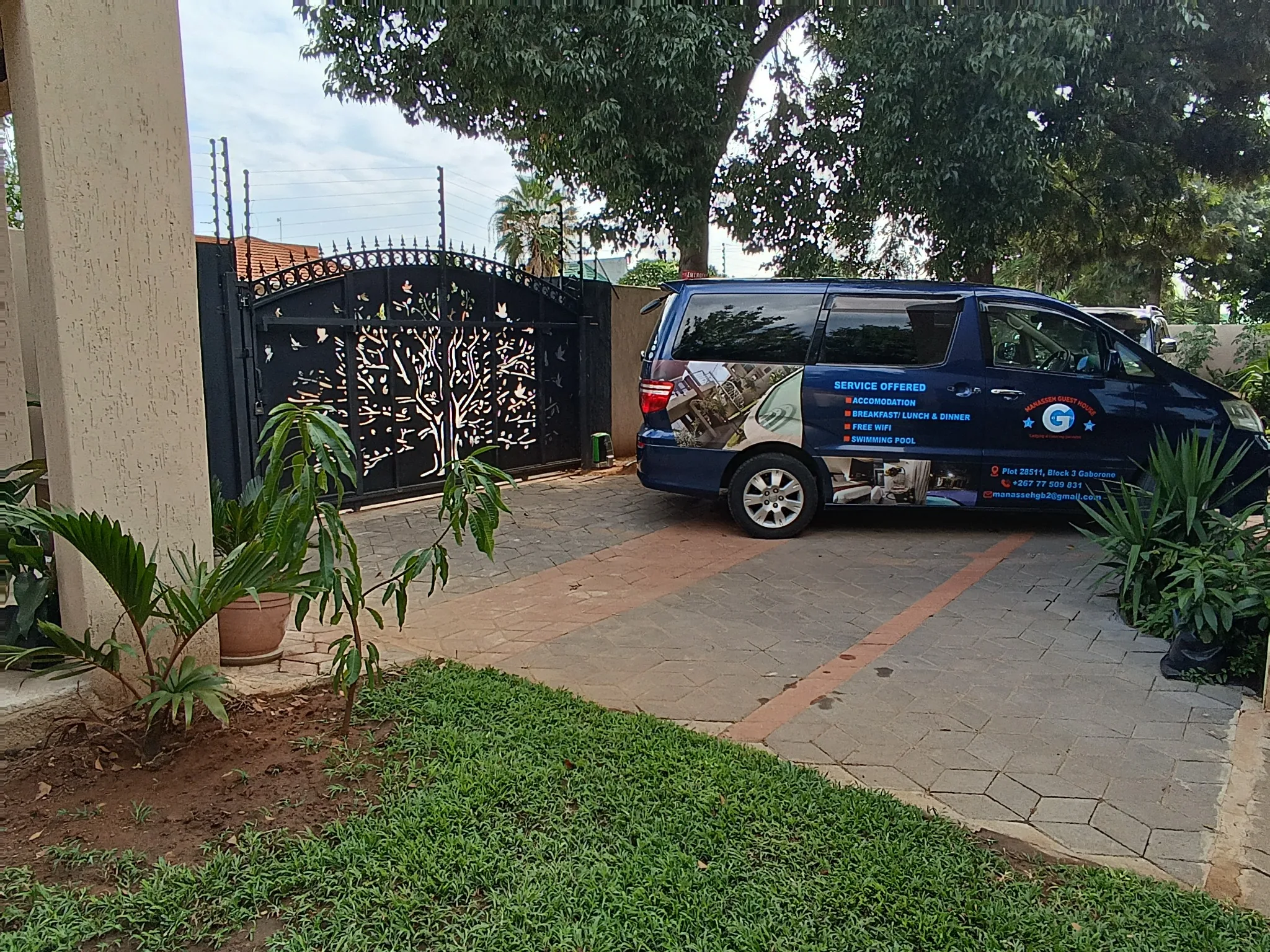 Manasseh Guest House transfer vehicle at the property entrance